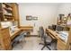 Home office with built-in wooden desk, cabinets, and natural lighting at 7400 Oakbay Dr, Noblesville, IN 46062