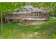 Brick home featuring a deck overlooking a spacious yard, with a screened in sunroom, perfect for outdoor living at 7400 Oakbay Dr, Noblesville, IN 46062
