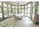 Bright sunroom featuring many windows, a ceiling fan, and outdoor views at 7400 Oakbay Dr, Noblesville, IN 46062