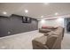 Finished basement featuring a large sectional sofa and a mounted TV at 7632 Nestucca Trl, Noblesville, IN 46062