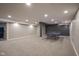 Spacious finished basement features neutral carpet, recessed lighting, and a ping pong table for entertainment at 7632 Nestucca Trl, Noblesville, IN 46062
