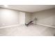 Finished basement offers neutral carpet, a white door and trim, and workout equipment at 7632 Nestucca Trl, Noblesville, IN 46062