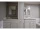 Bathroom featuring white cabinets, dual sinks with chrome hardware, quartz countertops, and framed mirrors at 7632 Nestucca Trl, Noblesville, IN 46062