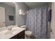 Bathroom with modern fixtures, a vanity with sink, and a shower-tub combination with blue curtain at 7632 Nestucca Trl, Noblesville, IN 46062