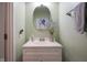 Charming half-bathroom featuring a vanity with a white countertop and a decorative mirror at 7632 Nestucca Trl, Noblesville, IN 46062