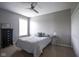 Serene bedroom with neutral walls, carpet, ceiling fan, and ample natural light at 7632 Nestucca Trl, Noblesville, IN 46062