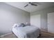 Comfortable bedroom with soft carpet, a ceiling fan, and a large window for natural light at 7632 Nestucca Trl, Noblesville, IN 46062