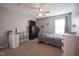 Bedroom featuring a bed, desk, dresser, and ceiling fan with a window at 7632 Nestucca Trl, Noblesville, IN 46062