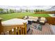 Inviting deck with wicker seating, a fire pit table, and a hot tub, perfect for outdoor entertaining at 7632 Nestucca Trl, Noblesville, IN 46062