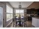 Bright dining area with a modern chandelier and large windows overlooking the backyard at 7632 Nestucca Trl, Noblesville, IN 46062