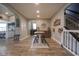 Open concept dining room with a high top table, wood floors and staircase access at 7632 Nestucca Trl, Noblesville, IN 46062