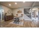 Open concept dining room highlighting wood floors, staircase and a rustic buffet at 7632 Nestucca Trl, Noblesville, IN 46062