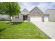 Beautiful brick home with a well-manicured lawn and a two-car garage on a sunny day at 7632 Nestucca Trl, Noblesville, IN 46062
