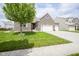 Charming brick home featuring a manicured lawn, three-car garage, and inviting front entrance at 7632 Nestucca Trl, Noblesville, IN 46062