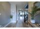Hallway featuring wood floors, arched doorways, and a view of the staircase and living room at 7632 Nestucca Trl, Noblesville, IN 46062