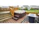 Relaxing backyard deck featuring a hot tub with steps and a cozy fire pit area for gatherings at 7632 Nestucca Trl, Noblesville, IN 46062