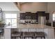 Open kitchen featuring a large island with seating, granite counters, and stainless steel appliances at 7632 Nestucca Trl, Noblesville, IN 46062