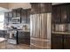 Well-equipped kitchen with stainless steel appliances and sleek dark cabinetry at 7632 Nestucca Trl, Noblesville, IN 46062