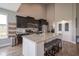 Spacious kitchen with a large island, granite countertops, and dark wood cabinets at 7632 Nestucca Trl, Noblesville, IN 46062