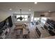 Open-concept living area with hardwood flooring, comfortable seating, kitchen, and ample natural light at 7632 Nestucca Trl, Noblesville, IN 46062