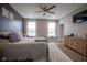Relaxing main bedroom with a ceiling fan, dresser, and large windows at 7632 Nestucca Trl, Noblesville, IN 46062