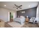 Serene main bedroom with a cozy chair, soft rug, and ensuite bathroom access at 7632 Nestucca Trl, Noblesville, IN 46062