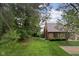 Scenic backyard with lush green grass and mature trees at 774 Chapel Pines W Dr, Indianapolis, IN 46234