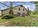 Backyard view of a home featuring a patio area, a mature tree, and a well-manicured lawn at 774 Chapel Pines W Dr, Indianapolis, IN 46234