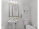 Clean half bath with pedestal sink, medicine cabinet, and toilet at 774 Chapel Pines W Dr, Indianapolis, IN 46234