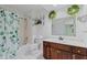 Light-filled bathroom with a shower-tub combination, wood vanity, and updated vanity lighting at 774 Chapel Pines W Dr, Indianapolis, IN 46234