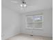 A bright bedroom featuring neutral carpet, white walls, and a window overlooking the backyard at 774 Chapel Pines W Dr, Indianapolis, IN 46234