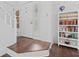 Bright entryway with hardwood floors, white trim, and a charming bookshelf at 774 Chapel Pines W Dr, Indianapolis, IN 46234
