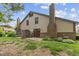 The home features a cozy patio area, complemented by lush landscaping around the base, perfect for outdoor enjoyment at 774 Chapel Pines W Dr, Indianapolis, IN 46234