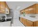 Well-lit kitchen with white countertops, stainless steel appliances, and wood cabinets at 774 Chapel Pines W Dr, Indianapolis, IN 46234
