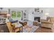 Inviting living room with a cozy fireplace, hardwood floors, and ample natural light at 774 Chapel Pines W Dr, Indianapolis, IN 46234