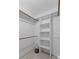 The walk-in closet has carpet floors and lots of built in shelving and hanging rods at 774 Chapel Pines W Dr, Indianapolis, IN 46234