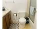 Modest bathroom with white toilet and wood vanity, plus white wall paint at 7844 Partridge Rd, Southport, IN 46227