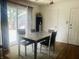 Bright dining area featuring a table with seating for four, with a sliding glass door, and hardwood floors at 7844 Partridge Rd, Southport, IN 46227
