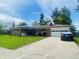 Charming single-story home featuring a brick facade, a well-manicured lawn, and an attached garage at 7844 Partridge Rd, Southport, IN 46227