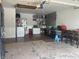 Spacious garage with white appliances, storage, and concrete flooring at 7844 Partridge Rd, Southport, IN 46227