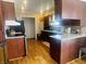 Functional kitchen with wooden cabinetry, laminate countertops, and essential appliances for a practical cooking space at 7844 Partridge Rd, Southport, IN 46227