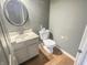 Powder room featuring a sink with white cabinets and a toilet at 817 Timber Creek Dr, Indianapolis, IN 46239
