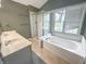 Bathroom featuring tub, shower, double sinks, and natural lighting at 817 Timber Creek Dr, Indianapolis, IN 46239