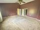 Large bedroom with vaulted ceilings, neutral carpet, and an open doorway at 817 Timber Creek Dr, Indianapolis, IN 46239