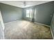 Bedroom with large window, neutral carpet, and a ceiling fan at 817 Timber Creek Dr, Indianapolis, IN 46239