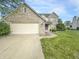Beautiful brick home featuring an attached two-car garage and a spacious driveway at 817 Timber Creek Dr, Indianapolis, IN 46239