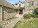 Charming brick home featuring a well-manicured lawn and a covered front porch at 817 Timber Creek Dr, Indianapolis, IN 46239