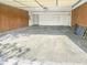 Spacious two car garage with wooden paneling and access doors at 817 Timber Creek Dr, Indianapolis, IN 46239