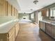 Well-lit kitchen with wood cabinets and view into the living area with fireplace at 817 Timber Creek Dr, Indianapolis, IN 46239