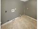 A gray walled laundry room with tile flooring and hookups for a washer and dryer at 817 Timber Creek Dr, Indianapolis, IN 46239